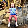 Mila joined the competition — help win amazing prizes! toddler, child, smiling, blue_shirt, pink_leggings, rock, bear_statue, indoor, floor, person, adult, seated, casual_clothing, shoes, socks, wood, background, happy, playful, museum