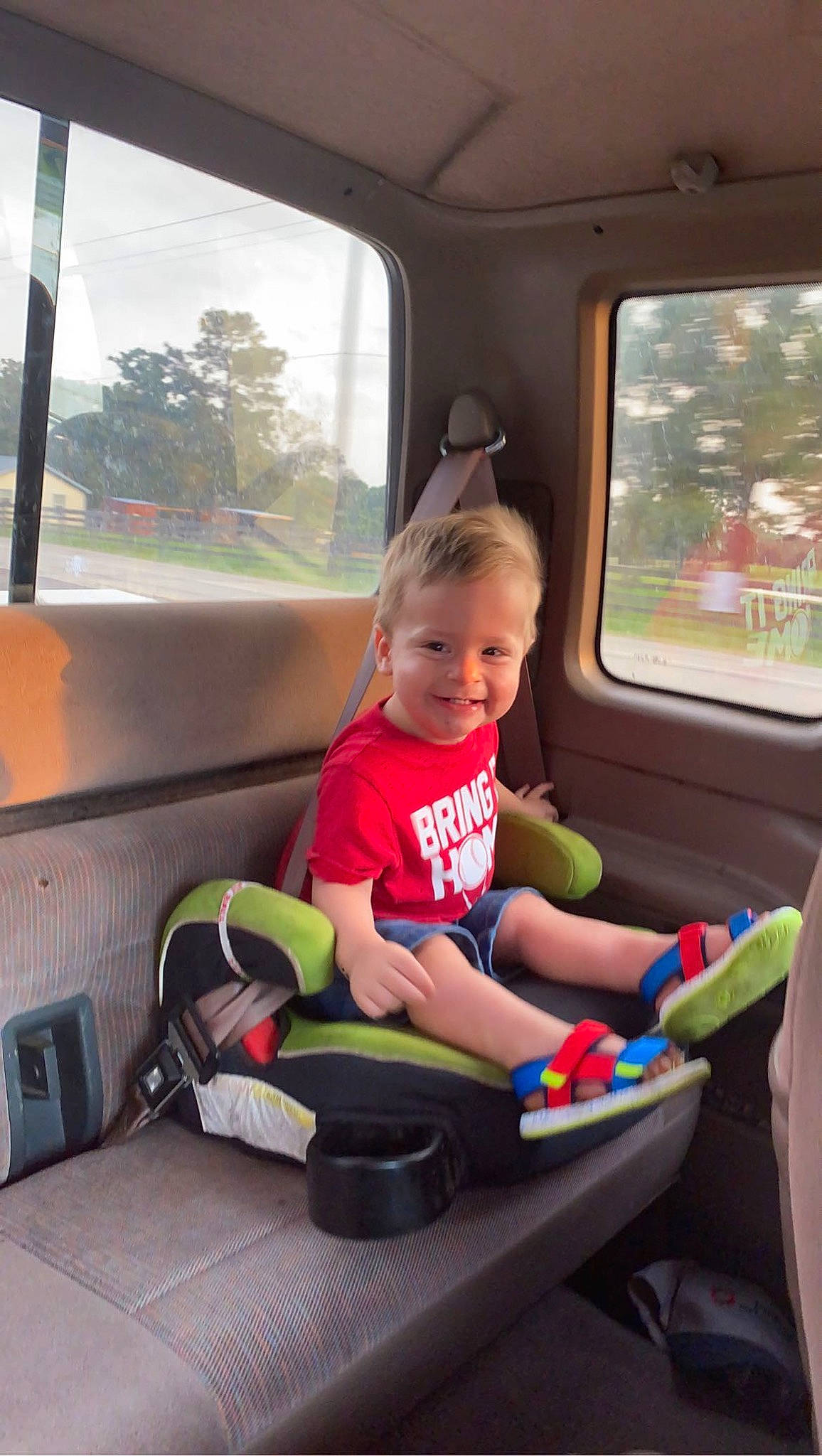 Kody is registered to the contest to win money with this photo: auto_part, automotive_design, automotive_exterior, car, car_seat, child, family_car, joy, leisure, mode_of_transport, motor_vehicle, person, smile, steering_wheel, thumb, toddler, toy, travel, tree, vehicle