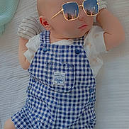 Liam joined the competition — help win amazing prizes! baby, infant, blue_checkered_overalls, mittens, white_blanket, sunglasses, reflection, cityscape, cute, sleeping, child, portrait, laying_down, soft_texture, fashion, indoors, peaceful, small_hands, comfortable, adorable