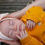 baby, sleeping, hands, headband, yellow_sweater, buttons, closeup, peaceful, infant, child, soft_lighting, portrait, cozy, skin, face, resting, newborn, cute, toddler, person
