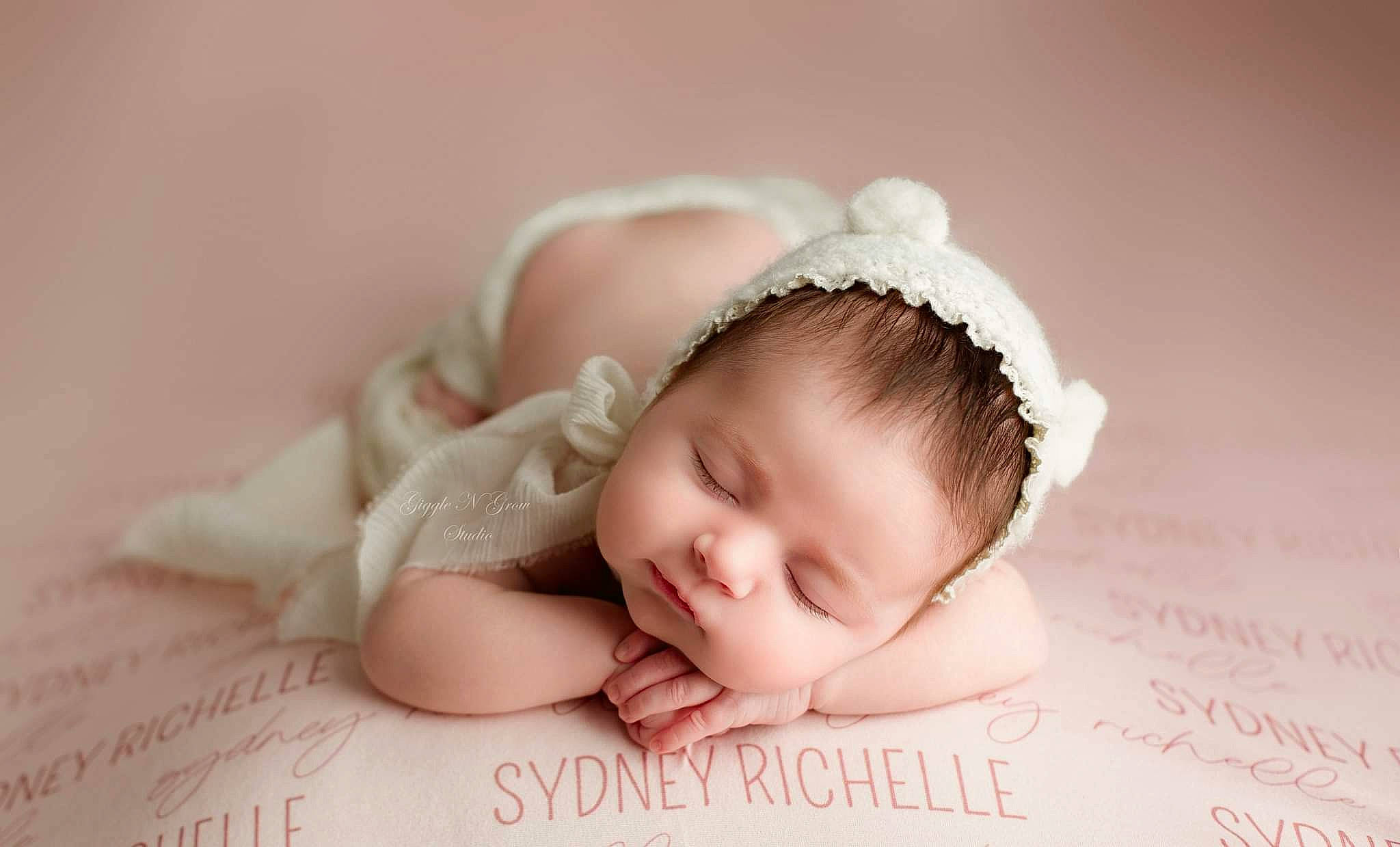 Sydney is registered to the contest to win money with this photo: baby, baby_sleeping, baby_toddler_clothing, cap, cheek, comfort, eye, eyelash, face, facial_expression, finger, flash_photography, hand, happy, headband, headpiece, iris, person, pink, skin