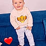toddler, child, smiling, sweater, simba, couch, blue_couch, socks, standing, indoor, cute, happy, person, baby, face, hair, pants, home, cozy, red_heart_emoji