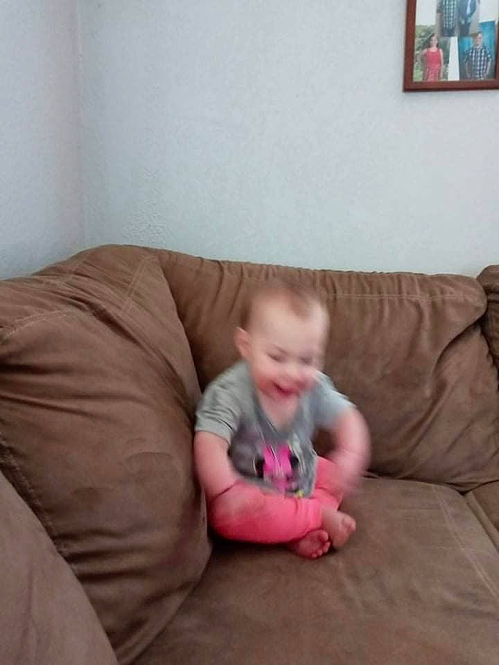 Emerson joined the competition — help win amazing prizes! baby, baby_toddler_clothing, barefoot, comfort, couch, flooring, foot, hardwood, joy, knee, linens, living_room, person, picture_frame, room, sitting, sleeve, smile, t_shirt, throw_pillow