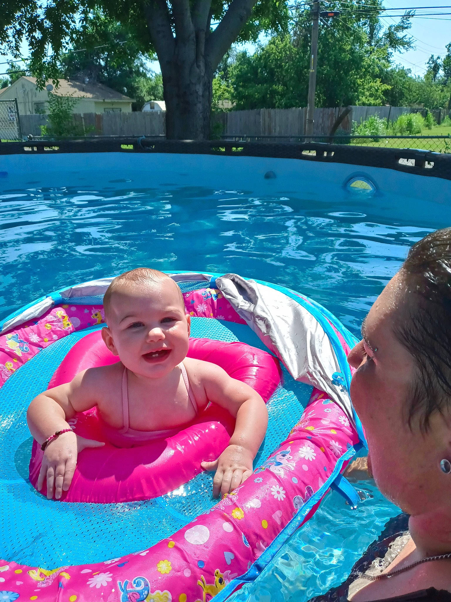 Emerson is registered to the contest to win money with this photo: aqua, baby, baby_float, baby_toddler_clothing, blue, body_of_water, child, fun, joy, leisure, outdoor_recreation, person, pink, product, recreation, sky, smile, summer, swimming_pool, toddler
