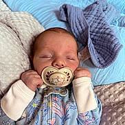 Grayson is registered to the contest to win money with this photo: baby, sleeping, pacifier, cute, blanket, soft, pastel_colors, infant, clothing, patterned, hands, face, resting, cozy, newborn, peaceful, cute_pacifier, bedtime, child, portrait