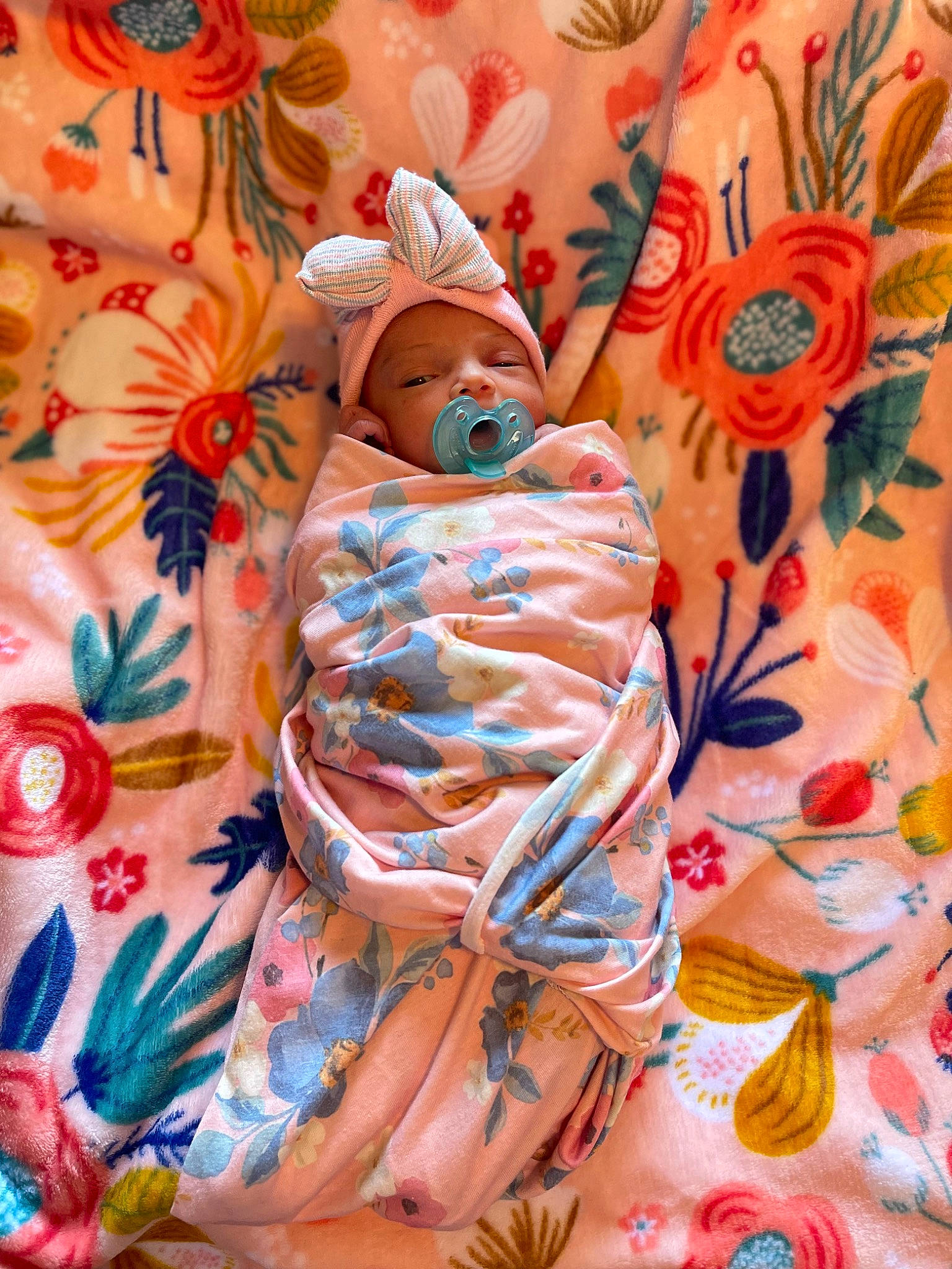 Kehlani is registered to the contest to win money with this photo: baby, baby_products, baby_toddler_clothing, child, dress, headwear, linens, orange, pattern, peach, person, petal, pink, sleeve, t_shirt, textile, toddler, visual_arts