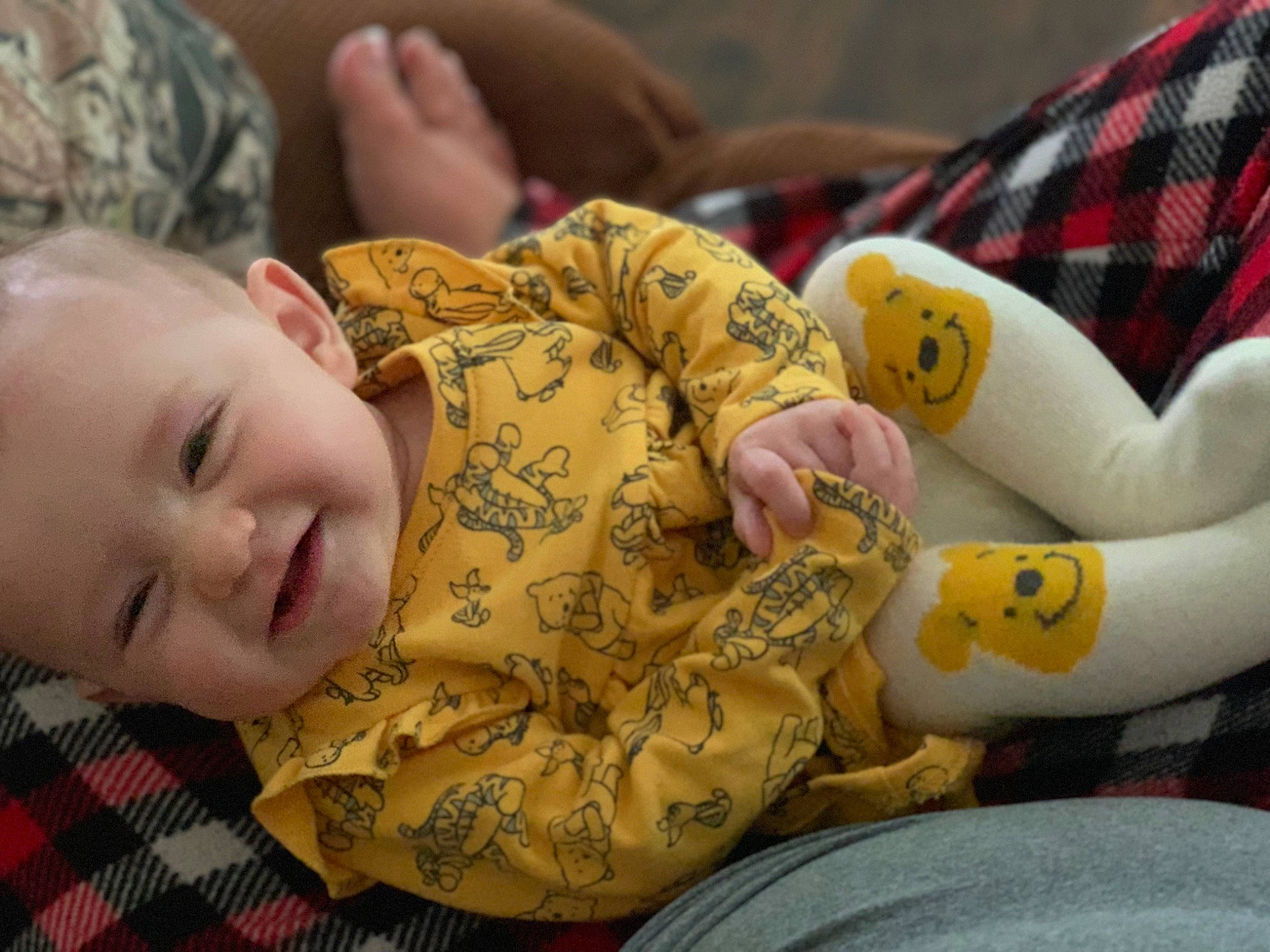 Willow is registered to the contest to win money with this photo: arm, baby, baby_toddler_clothing, cheek, comfort, facial_expression, finger, hand, happy, head, mammal, mouth, organ, person, product, skin, sleeve, smile, tartan, textile