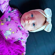 Oakley joined the competition — help win amazing prizes! baby, child, blue_eyes, headband, bow, purple_clothing, minnie_mouse, donald_duck, tutu, smiling, portrait, infant, cute, lying_down, close_up, soft_lighting, indoor, fashion, adorable, person