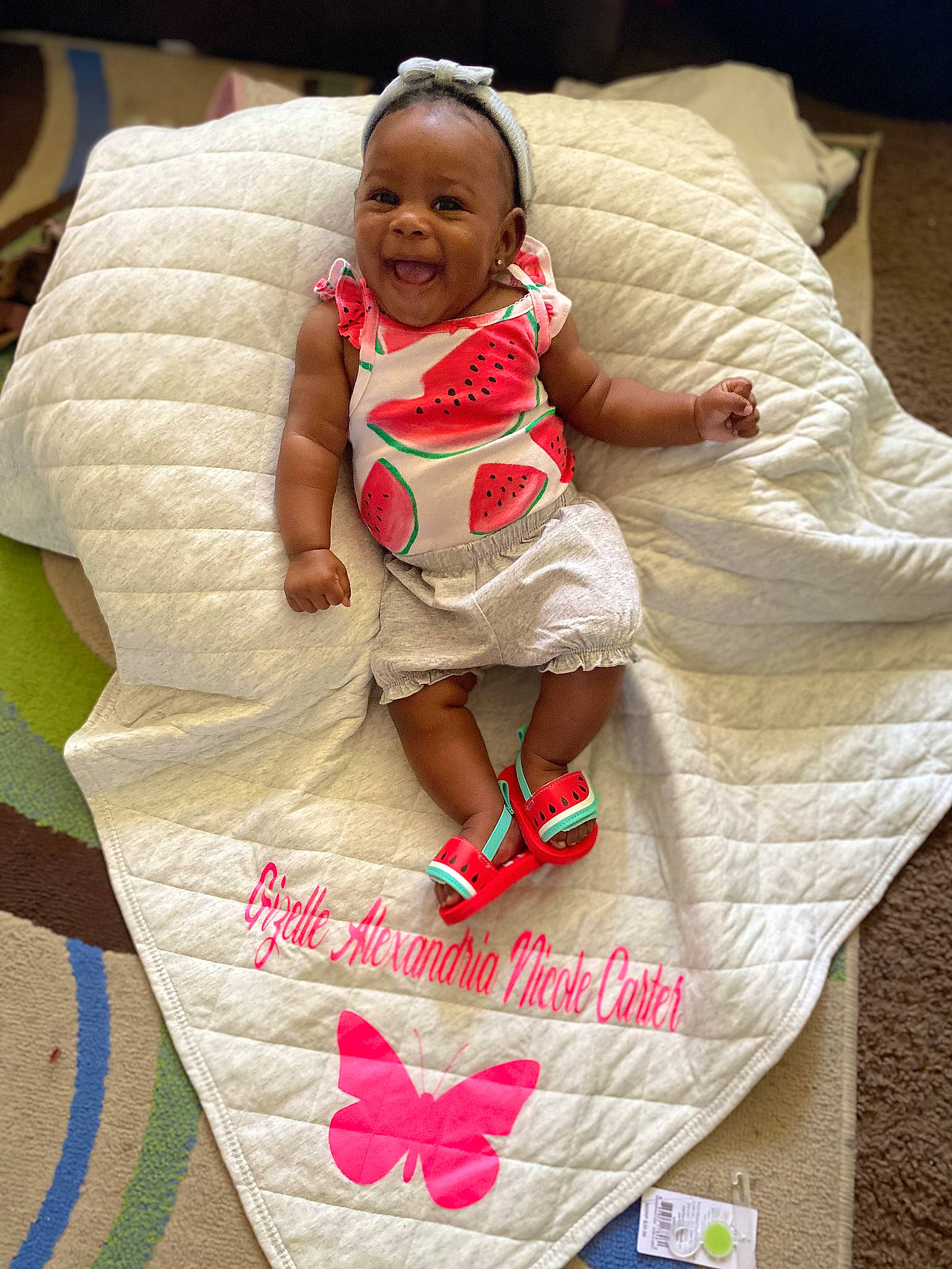 Gizelle is registered to the contest to win money with this photo: arm, baby, baby_toddler_clothing, child, comfort, cool, event, face, finger, flooring, fun, hand, happy, linens, organ, person, pink, sleeve, smile, t_shirt