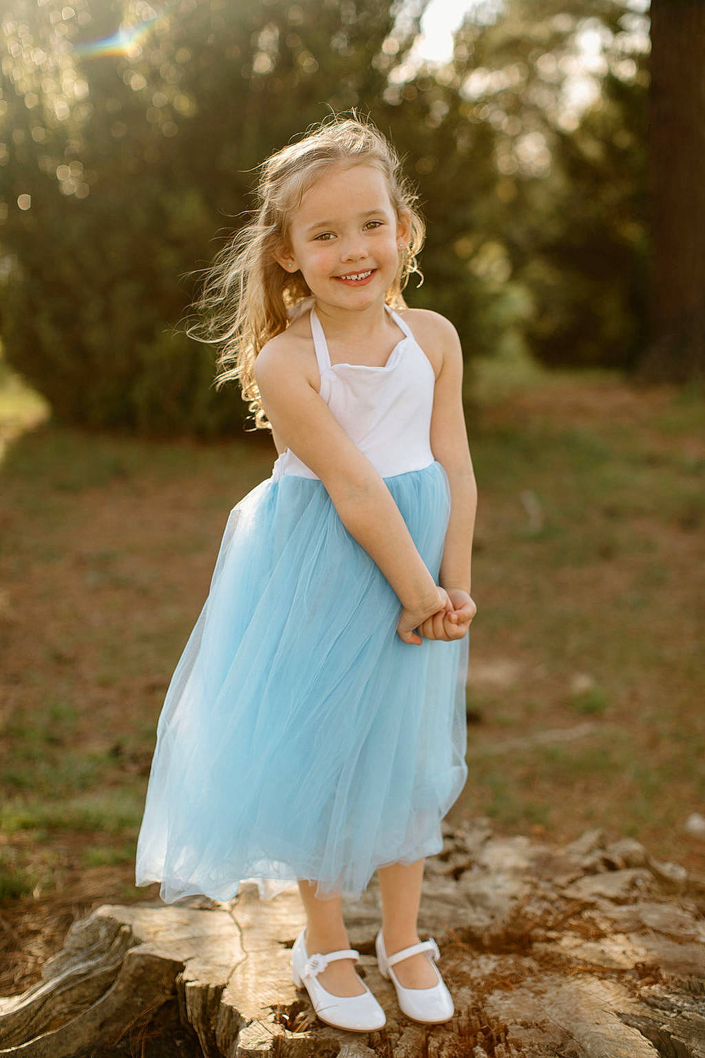 Macy is registered to the contest to win money with this photo: day_dress, dress, eye, face, flash_photography, footwear, formal_wear, grass, hairstyle, happy, head, joy, people_in_nature, person, plant, smile, sunlight, toddler, tree, trunk