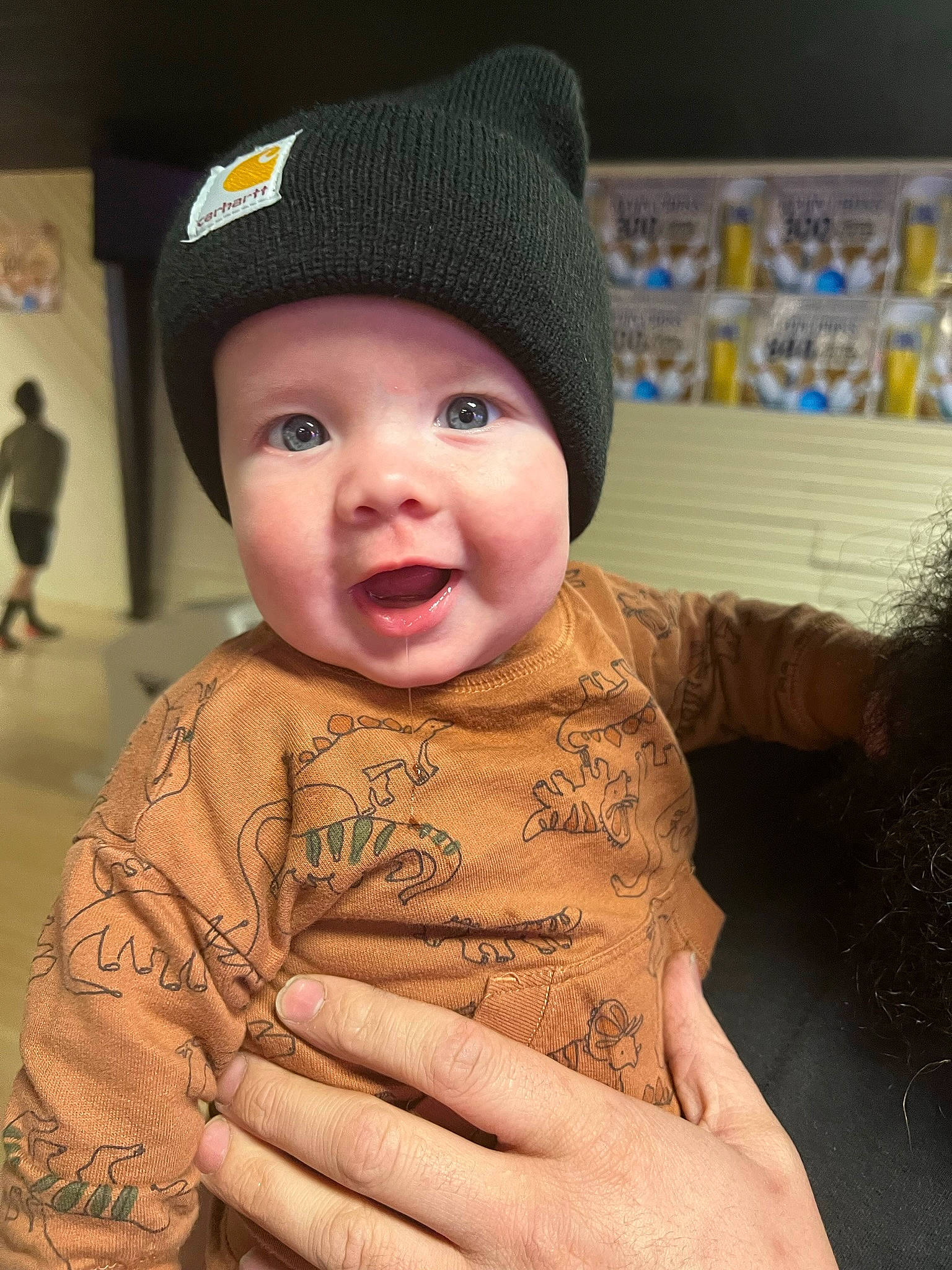 Carson is registered to the contest to win money with this photo: baby, baby_toddler_clothing, cap, cheek, child, chin, cool, eye, fashion_accessory, fun, gesture, happy, hat, head, headwear, nose, person, skin, sleeve, smile