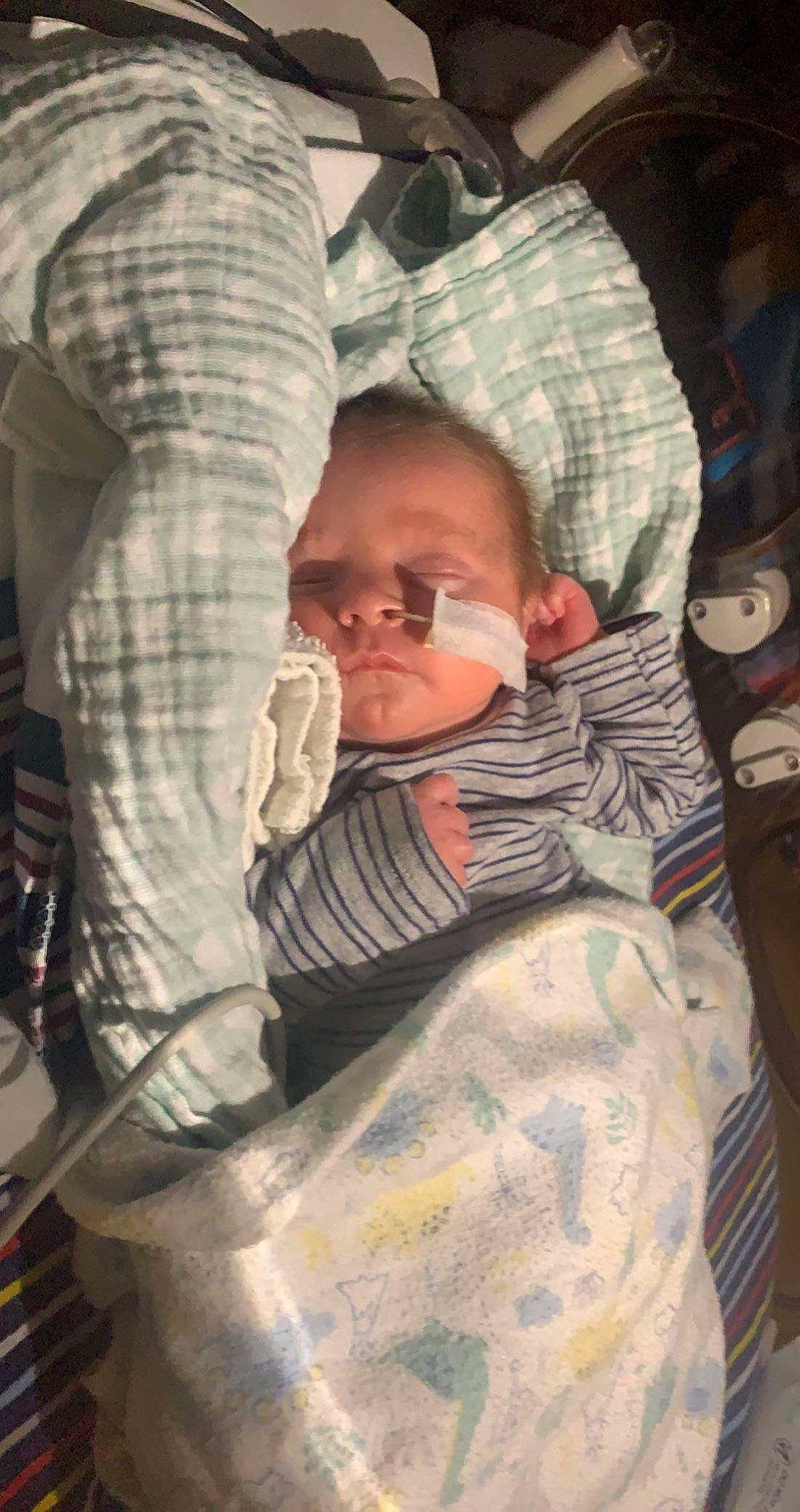 Bentley is registered to the contest to win money with this photo: baby, baby_carriage, baby_products, cap, child, eyewear, fun, glasses, goggles, hat, military, military_camouflage, pattern, person, personal_protective_equipment, sitting, soldier, sunglasses, toddler, tree