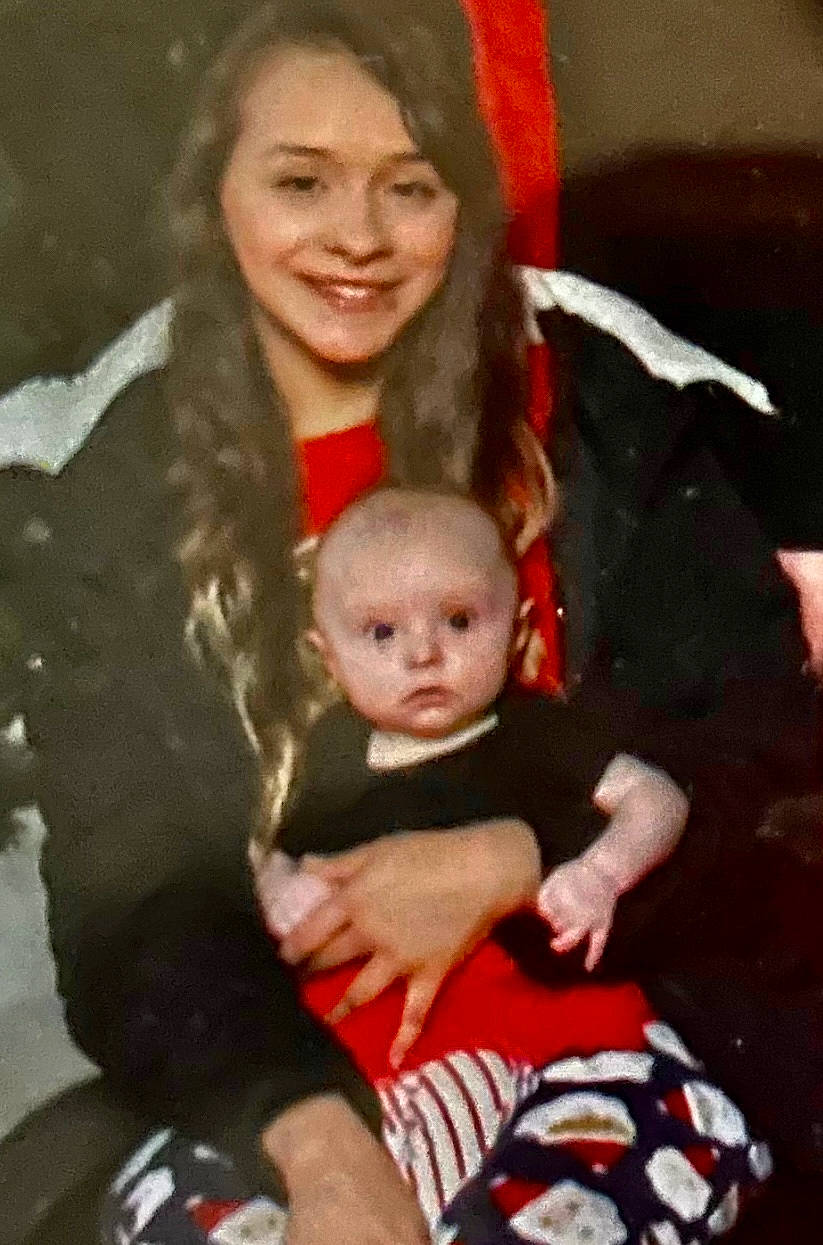 Kalani is registered to the contest to win money with this photo: baby, baby_toddler_clothing, cheek, child, christmas_eve, event, face, fun, hair, happy, head, holiday, iris, joy, lap, organ, person, shorts, sitting, smile