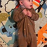 Athena is registered to the contest to win money with this photo: baby, infant, child, portrait, lying_down, play_mat, rainbow, butterflies, hair_clips, brown_outfit, hands, face, smiling, indoor, colorful, nursery, toys, cartoon, floor, photography