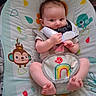 Athena joined the competition — help win amazing prizes! baby, child, infant, sitting, game_controller, gaming, toy, playful, curious, smiling, face, portrait, baby_seat, bouncer, blanket, colorful, jungle_theme, monkey, rainbow, indoor