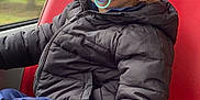 William participe au concours pour gagner de l'argent avec cette photo : beanie, blue_eyes, bus_seat, casual, child, closeup, hand, leg, pacifier, portrait, public_transport, puffer_jacket, red_seat, seat_back, sneaker, toddler, urban_background, window, winter_clothing, young_child