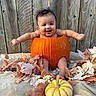 baby, child, pumpkin, pumpkin_costume, autumn, fall, leaves, gourd, orange, portrait, smiling, happy, outdoor, wooden_fence, seasonal, halloween, infant, sitting, photography, festive