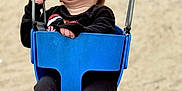 Rivhur is registered to the contest to win money with this photo: toddler, child, swing, playground, laughing, joyful, blue_swing, black_clothing, shoes, outdoor, sand, happy, baby, person, fun, chains, seat, smile, cute, motion
