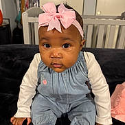 Zayah is registered to the contest to win money with this photo: baby, infant, child, headband, pink_bow, big_eyes, face, cheeks, onesie, denim_overall, long_sleeves, sitting, crib, couch, blanket, indoor, portrait, cute, hands, toes