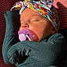 Sawyer is registered to the contest to win money with this photo: baby, child, closeup, clothing, colorful, cozy, cute, face, headband, indoors, infant, newborn, pacifier, peaceful, portrait, resting, sleeping, soft_light, warm_tones, wrapped
