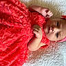 Sawyer joined the competition — help win amazing prizes! baby, blanket, child, clothing, cute, fabric, face, flower_pattern, hands, headband, indoors, infant, lying_down, newborn, peaceful, person, portrait, red_dress, skin, soft_texture