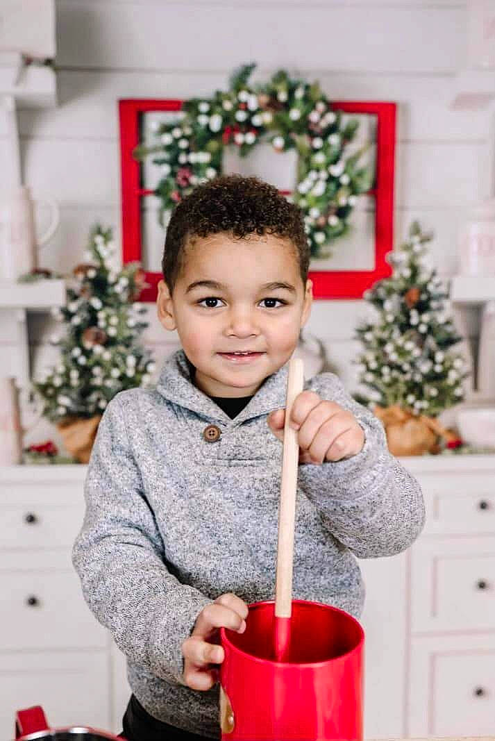Graysen is registered to the contest to win money with this photo: baby_toddler_clothing, child, christmas, christmas_decoration, christmas_eve, christmas_ornament, christmas_tree, event, face, happy, holiday, joy, ornament, pattern, person, portrait_photography, red, room, sitting, sleeve