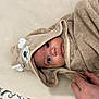 baby, towel, hood, bear, face, hand, skin, eyes, infant, cute, child, wrapped, soft, texture, beige, warm, cozy, indoor, person, portrait