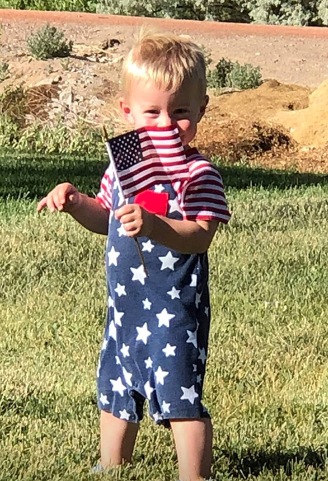 Josiah joined the competition — help win amazing prizes! baby_toddler_clothing, child, fun, gesture, grass, grass_family, grassland, happy, human_leg, lawn, meadow, pattern, people_in_nature, person, plant, sleeve, spring, summer, t_shirt, toddler