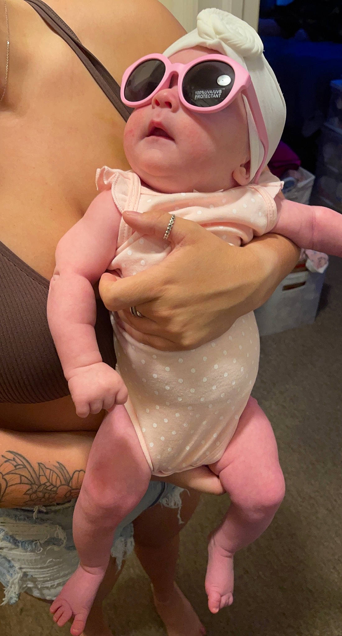 Alaina is registered to the contest to win money with this photo: abdomen, baby, blond, chest, eyewear, finger, gesture, goggles, happy, human_leg, joint, leg, muscle, person, pink, sunglasses, thigh, thumb, toddler, trunk