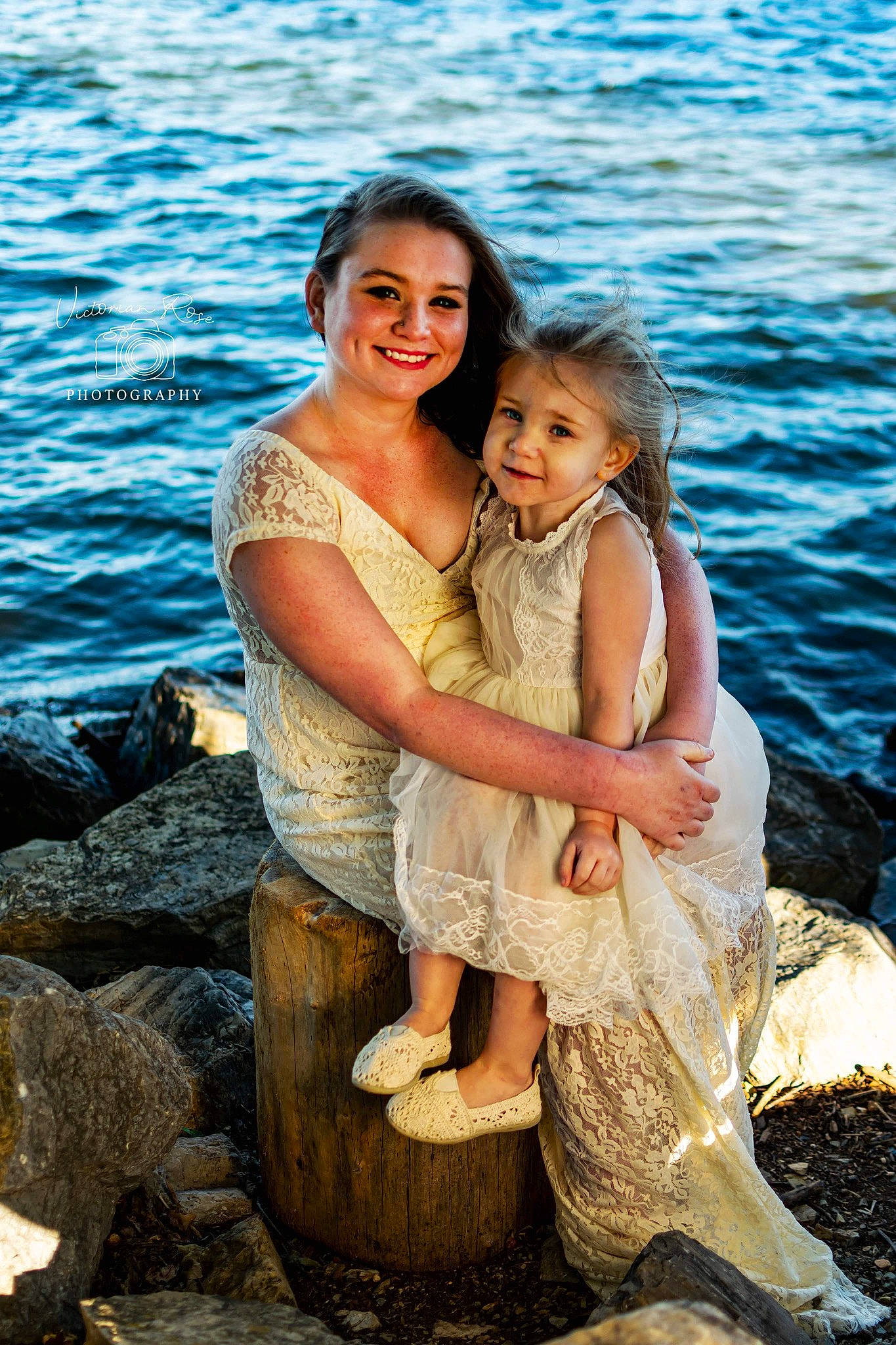Marlie is registered to the contest to win money with this photo: child, dress, family, friendship, fun, happy, hug, interaction, joy, long_hair, people, person, photograph, photography, portrait, rock, sea, sitting, smile, summer