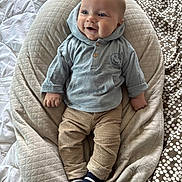 Adonis a rejoint le concours — aidez-le/la à gagner de superbes lots ! baby, infant, smiling, hooded_sweatshirt, pants, striped_socks, pillow, quilted_pillow, blanket, polka_dot, bed, hands, legs, portrait, indoor, cozy, cute, blue_clothing, beige_tones, soft_texture