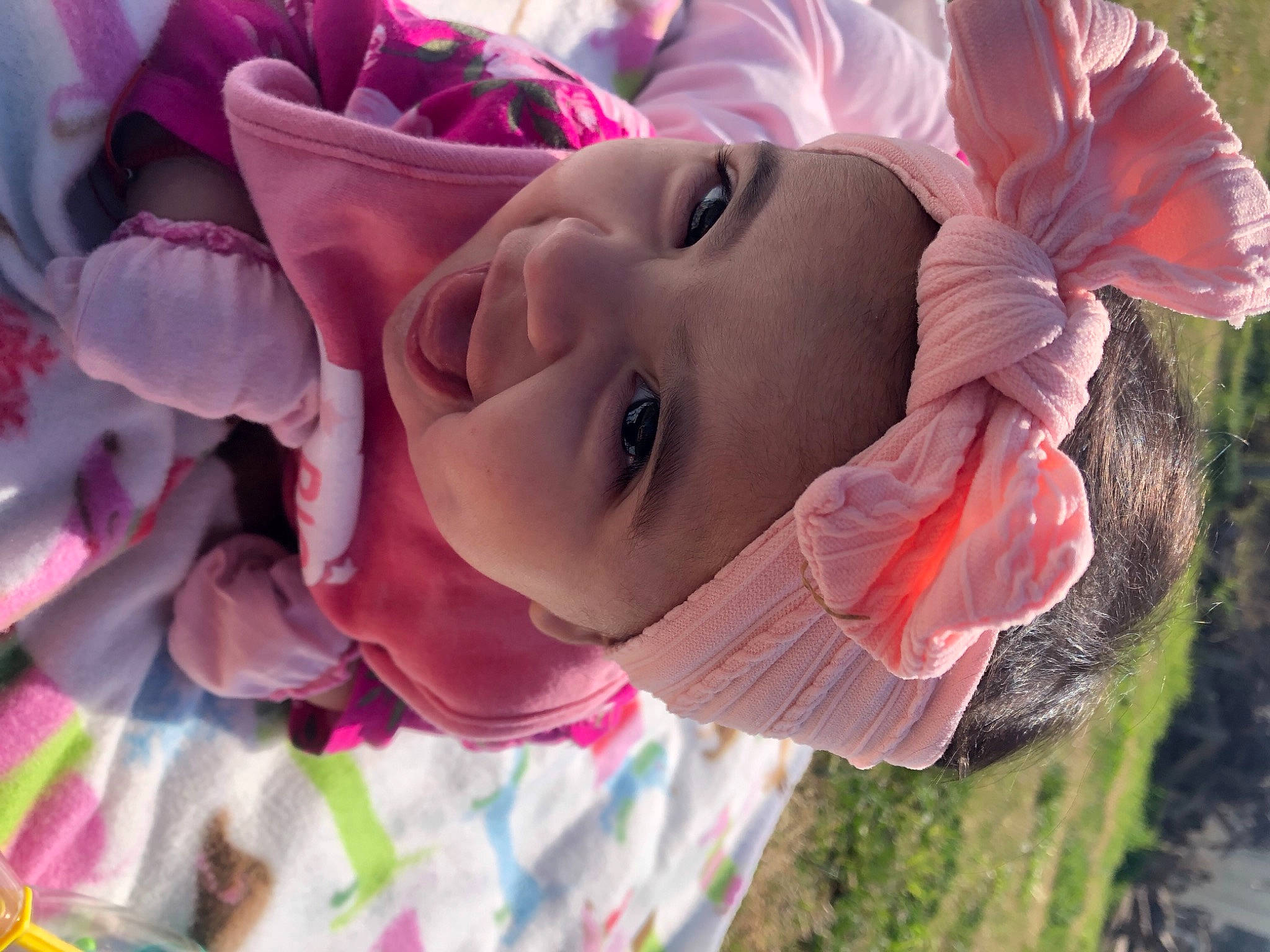 Malayah joined the competition — help win amazing prizes! baby, face, fun, grass, happy, hat, headwear, leaf, light, lip, mouth, nose, people_in_nature, person, pink, plant, red, skin, smile, toddler