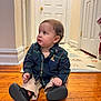 baby, child, sitting, floor, wooden_floor, shirt, plaid, pants, shoe, indoor, hallway, door, curious, person, young_child, casual_clothing, footwear, home, portrait, looking_away