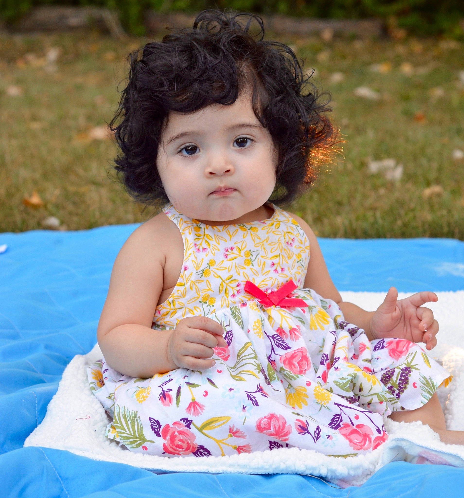 Emiliana is registered to the contest to win money with this photo: baby, baby_toddler_clothing, child, child_model, dress, pattern, person, sitting, toddler