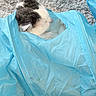 cat, kitten, black_and_white, fluffy, sleeping, curled_up, cozy, blanket, blue_blanket, wrapped, indoors, carpet, home, pet, animal, fur, ears, resting, cute, portrait