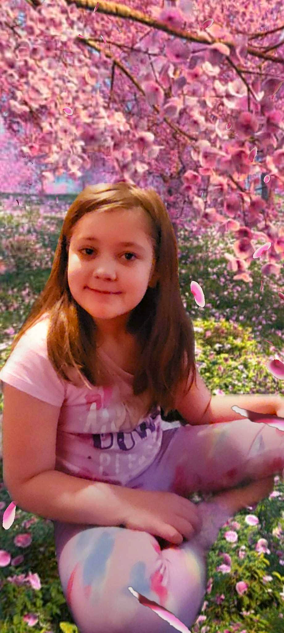 Jazmyn is registered to the contest to win money with this photo: beauty, blond, botany, brown_hair, face, flower, grass, happy, joy, leaf, leisure, lip, long_hair, nature, people_in_nature, person, petal, pink, plant, smile