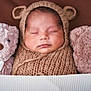 Liam joined the competition — help win amazing prizes! baby, sleeping, teddy_bear, knit_hat, blanket, cozy, cute, infant, soft_toys, brown, child, portrait, wrapped, headgear, peaceful, resting, cuddly, warm, indoors, closeup