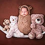 baby, swaddled, knit_outfit, bear_ears, hammock, teddy_bears, sleeping, cozy, brown_background, cute, soft_toys, infant, child, portrait, resting, adorable, plush, comfort, warm, peaceful