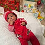 Liam is registered to the contest to win money with this photo: baby, blanket, celebration, child, christmas, cozy, cute, decorations, festive, floor, hat, holiday, indoors, infant, lying_down, portrait, presents, red_clothing, soft_texture, striped_clothing