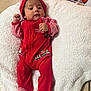 baby, blanket, child, christmas_outfit, cozy, cute, face, festive, floor_tiles, holiday, indoor, infant, lying_down, portrait, red_clothing, small_hands, soft_texture, striped_hat, striped_socks, white_blanket