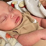 Dylan is registered to the contest to win money with this photo: baby, sleeping, blanket, infant, peaceful, closeup, soft, cozy, skin, face, arm, clothing, newborn, rest, indoors, toddler, cute, portrait, comfort, relaxation