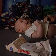 Roman joined the competition — help win amazing prizes! baby, blanket, bed, child, clothing, controller, diaper_wipes, expression, face, hand, indoor, joy, laying_down, person, play, smile, toy, wipes, young_child, gaming