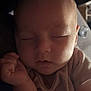apparel, baby, calm, child, closeup, cozy, cute, face, hand, indoors, infant, newborn, peaceful, person, portrait, resting, skin, sleeping, soft_light, striped