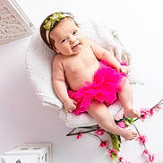 Lou-Anna a rejoint le concours — aidez-le/la à gagner de superbes lots ! baby, child, smiling, pink_tutu, headband, flower, knitted_blanket, white_chair, pink_flowers, portrait, cute, happy, infant, indoor, decor, soft_lighting, relaxed, skin, pretty, adorable