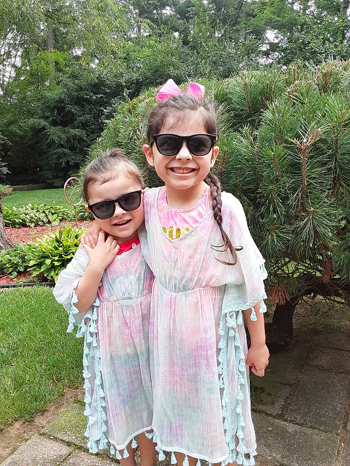Sofia is registered to the contest to win money with this photo: baby_toddler_clothing, day_dress, dress, eyewear, gesture, glasses, goggles, grass, happy, joy, leisure, person, pink, plant, recreation, sleeve, smile, summer, sunglasses, toddler