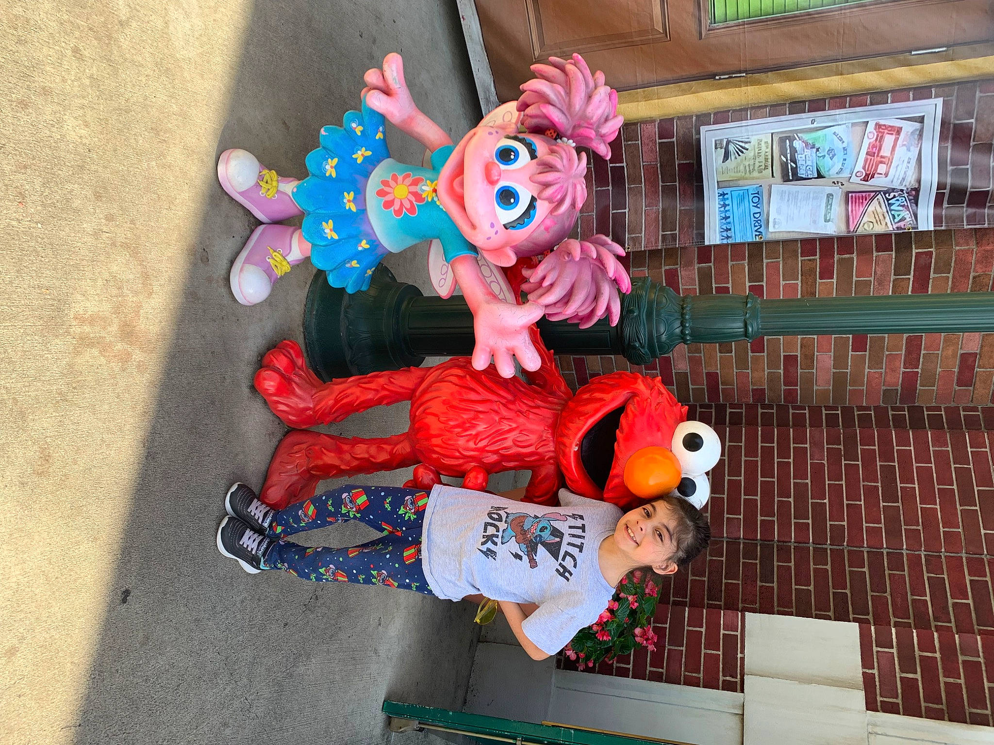 Isabella is registered to the contest to win money with this photo: animated_cartoon, animation, art, carmine, child, costume, event, fiction, fictional_character, fun, joy, leisure, mascot, person, plastic, plush, recreation, stuffed_toy, toy