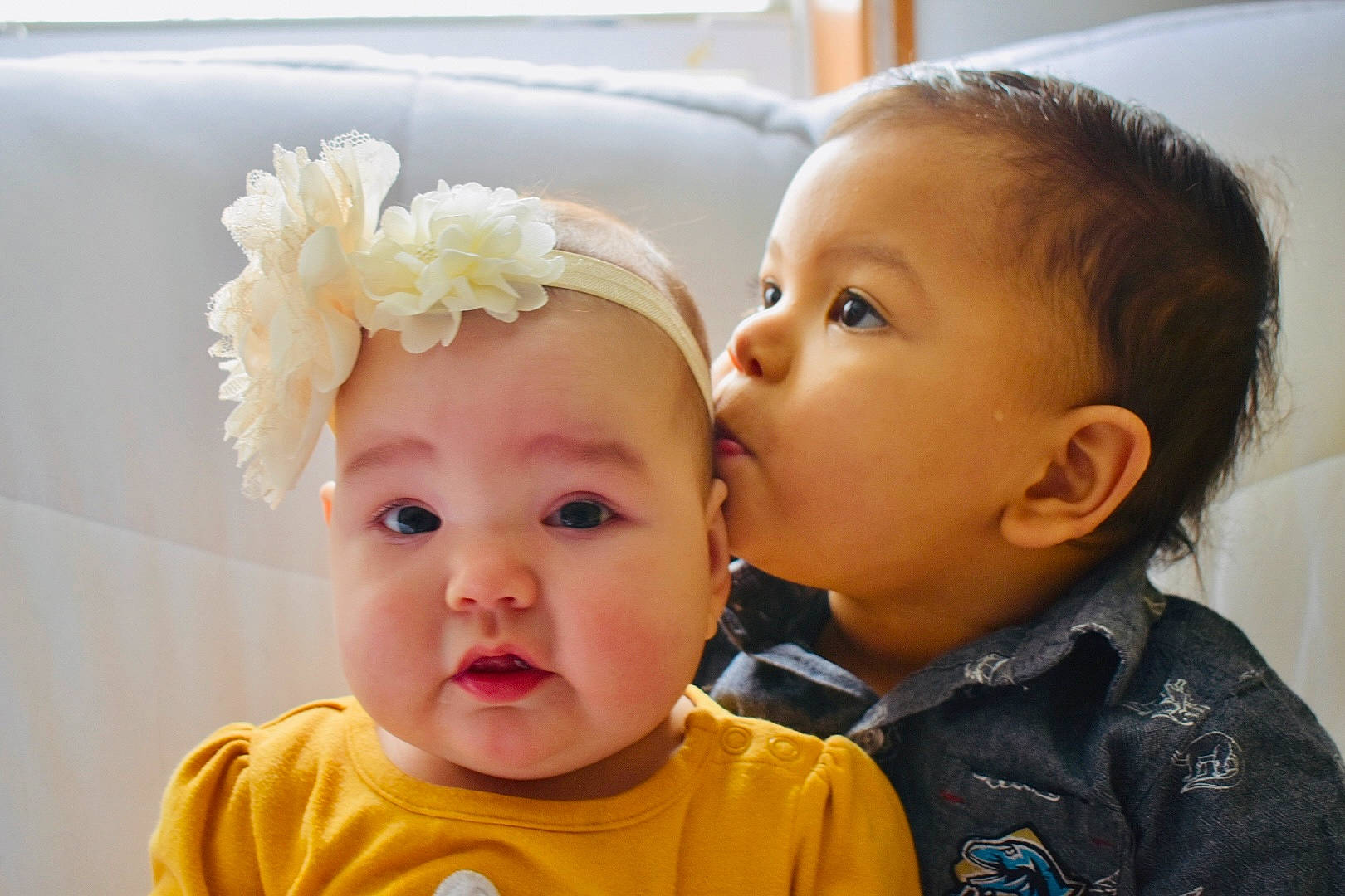 Josiah is registered to the contest to win money with this photo: baby, baby_toddler_clothing, cheek, child, close_up, ear, eyelash, face, flower, fun, happy, headwear, iris, kiss, lip, nose, person, petal, plant, sharing