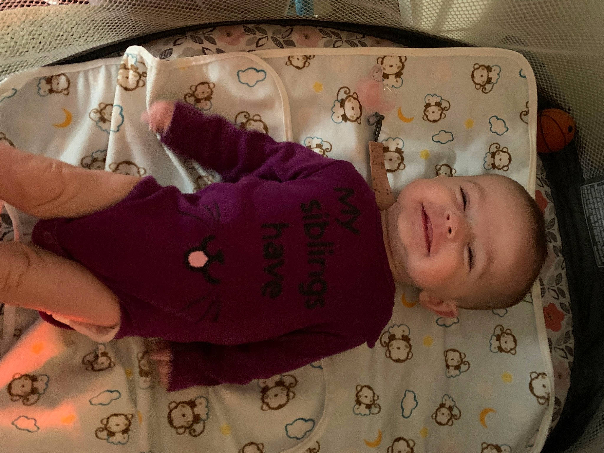 Nova is registered to the contest to win money with this photo: arm, baby, baby_products, baby_toddler_clothing, cheek, child, comfort, fashion_accessory, gesture, hand, linens, magenta, pattern, person, pink, skin, sleeve, textile, toddler, wood