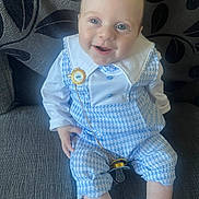 Abel joined the competition — help win amazing prizes! baby, blue_outfit, child, couch, cute, gold_chain, gray_fabric, happy, indoor, infant, leaf_pattern, pacifier, person, pillow, portrait, sitting, smiling, sock, white_collar, young