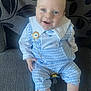 baby, blue_outfit, child, couch, cute, gold_chain, gray_fabric, happy, indoor, infant, leaf_pattern, pacifier, person, pillow, portrait, sitting, smiling, sock, white_collar, young